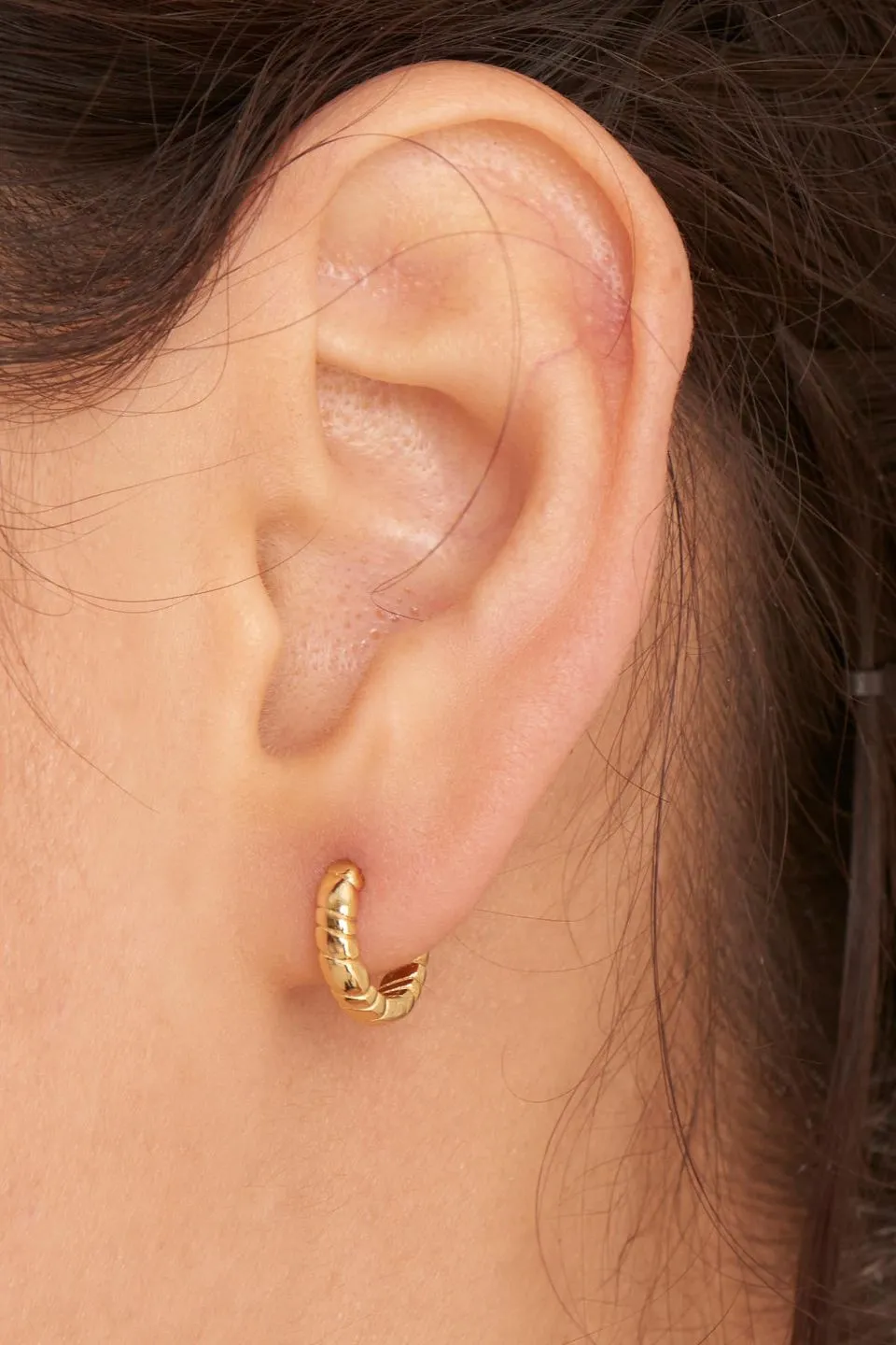 Smooth Operators Gold Twisted Huggie Earrings
